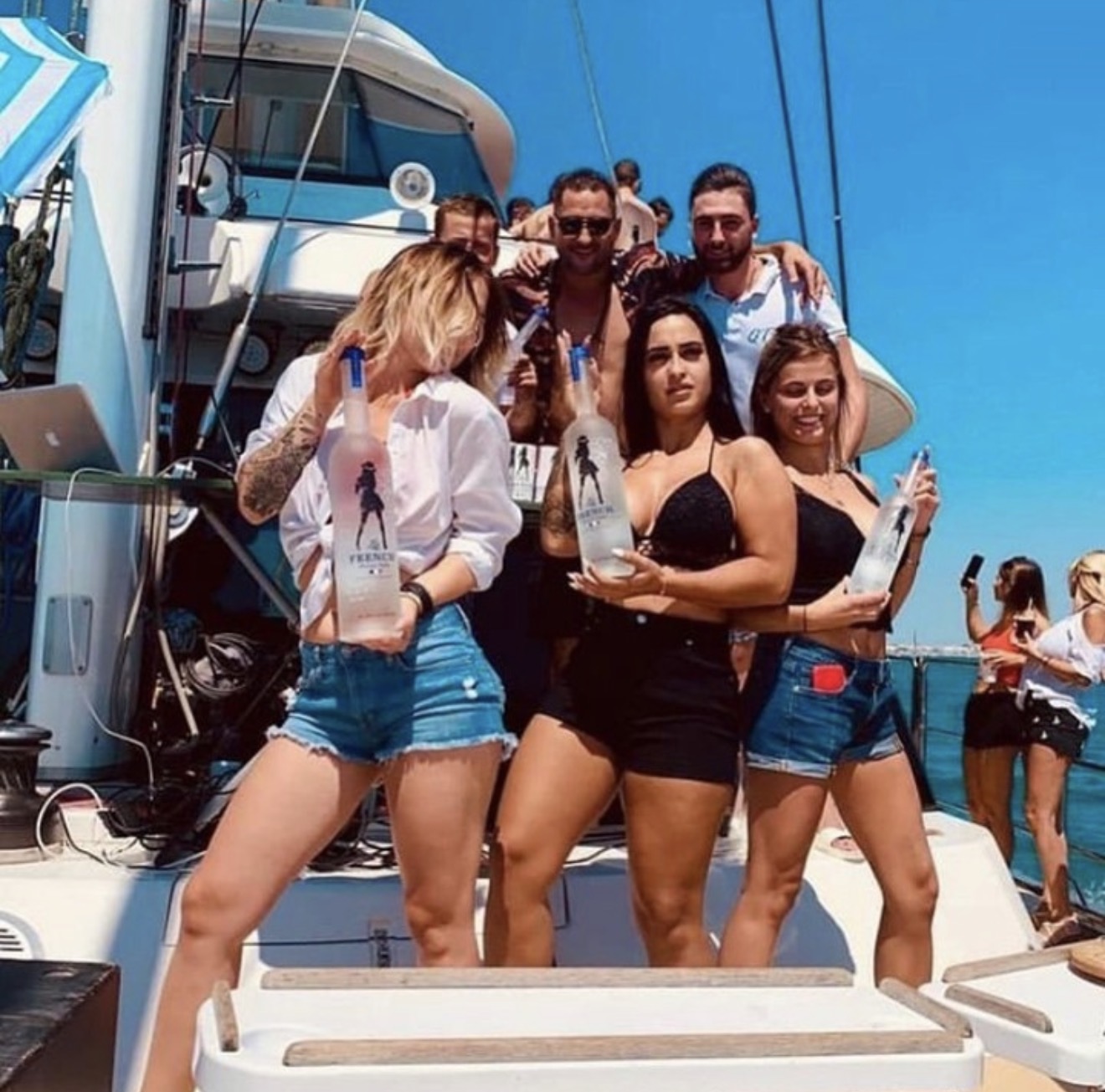Friends celebrating with La French Vodka on a boat